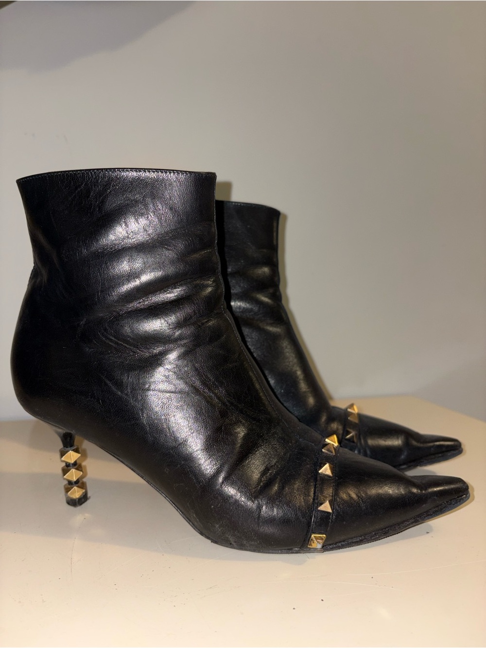 Valentino Garavani Black Leather Pointed Ankle Booties with Gold Stud Heels